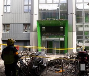 A firefighter stands outside of the Grenfell Tower after fire engulfed the 24-story building.