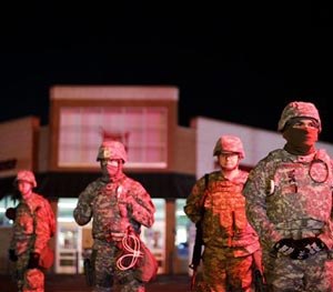 Missouri National Guard stand watch outside a Walgreens store, Wednesday, Nov. 26, 2014, in Ferguson, Mo. (AP Image)