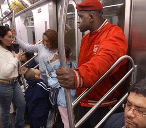 Guardian Angel Eric Jackson, right, looks around while patrolling a subway car in New York, Thursday, June 19, 2003.