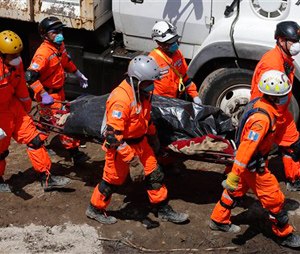 Rescuers carry a body recovered on the fourth day of searching for victims of a mudslide in Cambray, a neighborhood of Santa Catarina Pinula, Guatemala.