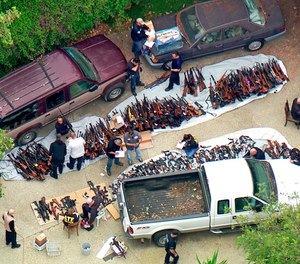 investigators from the U.S. Bureau of Alcohol, Tobacco, Firearms and Explosives and the police inspecting a large cache of weapons seized at a home in the affluent Holmby Hills area of Los Angeles Wednesday, May 8, 2019.