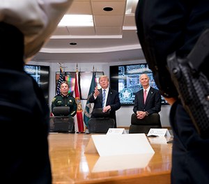 President Donald Trump, center, accompanied by Broward County Sheriff Scott Israel, left, and Florida Gov. Rick Scott, right, speaks as they meet with law enforcement officers at Broward County Sheriff's Office in Pompano Beach, Fla., Friday, Feb. 16, 2018, following Wednesday's shooting at Marjory Stoneman Douglas High School, in Parkland, Fla.