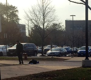 In this Nov. 19, 2018, photo, Juan Lopez stands over the body of his ex-fiancee, emergency room doctor Tamara O'Neal, after gunning her down in a parking lot near Mercy Hospital in Chicago.