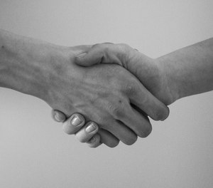 An inmate has just received his GED and reaches out to shake your hand. How do you respond?
