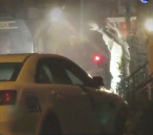In this image from video taken by Bill Trenwith on Wednesday, Aug. 14, 2019, a man exits a building with hands up in Philadelphia, Pennsylvania. (Photo/Bill Trenwith via AP)
