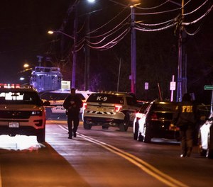 Authorities gather on a street in Monsey, N.Y., Sunday, Dec. 29, 2019, following a stabbing late Saturday during a Hanukkah celebration.