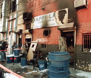 In this 1990 file photo, news crews report on an arson fire at the Happy Land social club in which 87 people perished, in the Bronx borough of New York.