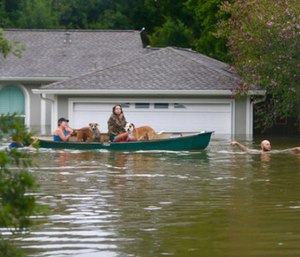 A family evacuates their Meyerland home in Houston. (Photo/AP)
