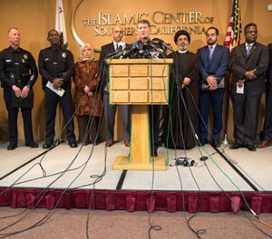 Michael Downing, LAPD Deputy Chief Counter-Terrorism, center, holds a news conference with members of law enforcement and the Muslim community after a series of letters threatening violence against Muslims, in Los Angeles on Nov. 28.