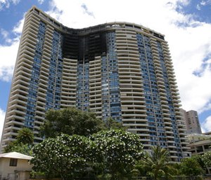 This photo shows the Marco Polo building after a fire gutted several of the top floors of the residential complex.