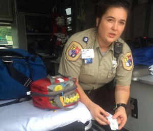 In this Aug. 28, 2016 photo, Cabell County EMT Tabitha Perez demonstrates how medics administer naloxone to overdosing patients, in Huntington, W.Va.