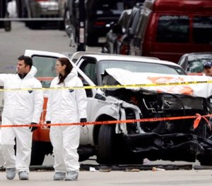 Law enforcement personnel examine the scene Wednesday, Nov. 1, 2017, after a driver mowed down people on a riverfront bike path near the World Trade Center on Tuesday in New York.
