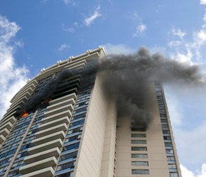 At least three people died and at least 12 were injured in a fire that broke out on the 26th floor of a Honolulu high-rise Friday, and hundreds fled from the giant apartment complex as smoke billowed from the upper floors, authorities said.