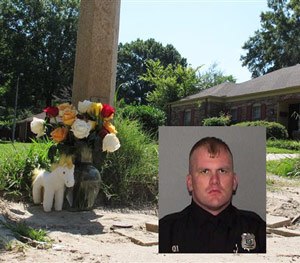 A makeshift memorial rests on the sidewalk Monday, Aug. 3, 2015, at the location where Memphis, Tenn., Police Officer Sean Bolton was fatally shot.