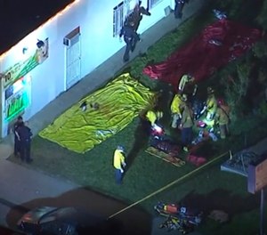 Aerial image made from video shows the scene where emergency workers have cordoned off an area after a shooting inside a home in Long Beach, Calif. (KABC via AP)