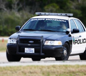 Officers put the man in handcuffs and in the back of a police cruiser. (Photo/ Houston Police Department)