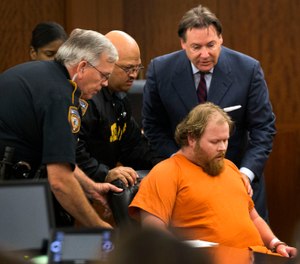 In this July 11, 2014 file photo, Ronald Lee Haskell collapses as he appears in court in Houston. (Brett Coomer/Houston Chronicle via AP, Pool)