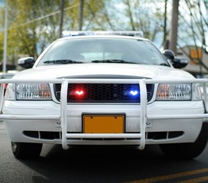 A police car blocking a road (Image/iStock)