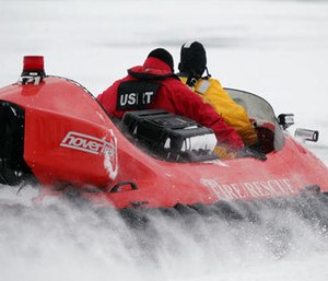 In this Feb. 13, 2017 photo, rescue crews use a hovercraft to search the frigid waters of Conesus Lake in Livonia, N.Y., for two missing snowmobilers who are believed to have fallen through the ice.