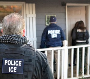 In this Feb. 9, 2017, photo provided U.S. Immigration and Customs Enforcement, ICE agents at a home in Atlanta, during a targeted enforcement operation aimed at immigration fugitives, re-entrants and at-large criminal aliens. (Bryan Cox/ICE via AP)