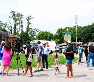 In this Monday, July 22, 2019 photo, media and concerned citizens gather outside a Nashville, Tenn., home, where an immigration agent gave up trying to arrest a Tennessee man.