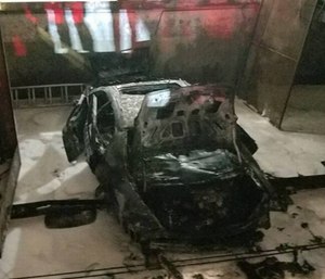 A car plummeted nine stories from a downtown Miami parking garage after it was left in gear and burst into flames. (Photo/MFR)
