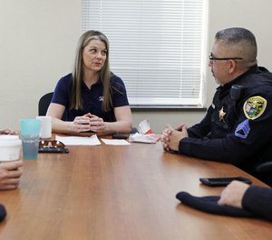 Hammond police Master Sgt. Tracy Betustak, center, speaks with Master Sgt. Joseph Martinez to discuss officer wellness among Hammond police officers.