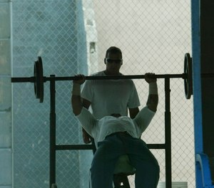 An inmate lifts weights at the Hendry Correctional Institution on Wednesday, April 11, 2007, in Immokalee, Fla. (AP Photo/Wilfredo Lee)