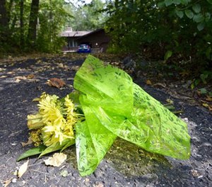 A bouquet of flowers is placed at the end of Jerry and Patty Wetterling's driveway as news has come out that the search for Jacob Wetterling may be over, Saturday afternoon, Sept. 3, 2016, in St. Joseph, Minn. (Kimm Anderson/St. Cloud Times via AP)