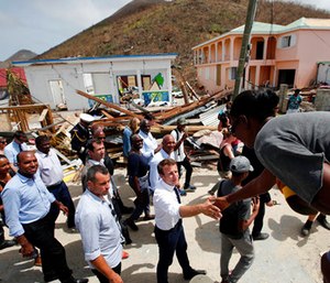France's President Emmanuel Macron shakes hands with residents during his visit in the French Caribbean islands of St. Martin.