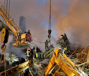 Iranian firefighters remove debris of the Plasco building which was engulfed by a fire and collapsed on Thursday, in central Tehran, Iran, Friday, Jan. 20, 2017.