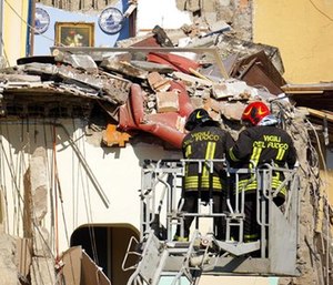 Firefighters work at the site where a building that collapsed in Torre Annunziata, near Naples, southern Italy, Friday, July 7, 2017. (Ciro Fusco/ANSA via AP)