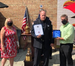Officer Jeffrey Waddell holds up his Officer of the Year award at the 2020 ceremony.