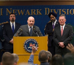 U.S. Attorney Craig Carpenito, center, speaks at a new conference to provide an update on the Dec. 10 Jersey City shootings at the FBI headquarters in Newark, N.J.