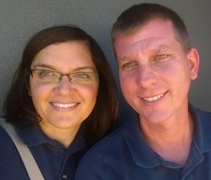 Jeannie and Jason sitting in a compartment in a ladder truck.