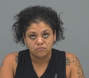 Shaina Johns, 28, was charged with aggravated assault for allegedly biting a paramedic at a hospital while she was already in police custody.