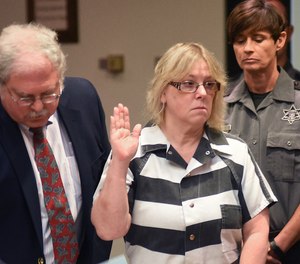 In this July 28, 2015 file photo, Joyce Mitchell raises her hand during a court appearance in Plattsburgh, N.Y.