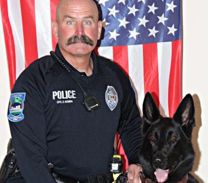 Mason City police officer Duane Kemna and K-9 Kilo pose for a picture.