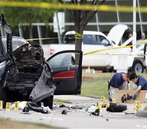 n this May 4, 2015 file photo, investigators box up an assault weapon while collecting evidence outside the Curtis Culwell Center, in Garland, Texas.