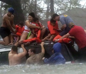 Bay St. Louis Emergency Management Agency volunteer crews rescue the Taylor family from the roof of their suburban, which became trapped on US 90 due to flooding during Hurricane Katrina, in this Aug. 29, 2005, photo in Bay St. Louis, Miss. (AP / Ben Sklar Photo)