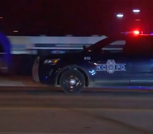 In this image made from video, a police vehicle passes with sirens near the scene of a shooting. Police say at least two people are dead and upwards of a dozen people may have been injured in a shooting outside a bar. (Photo/AP)