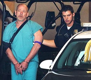 Sandy Police escort suspected kidnapper Troy Morley to a police car for transport to the Salt Lake County Jail, Friday.