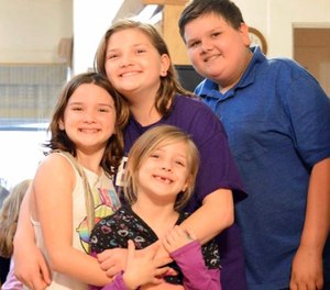 This 2017 photo provided by Torie McCallum shows Sutherland Springs First Baptist Church shooting victims, from left, Megan Hill, Emily Hill, Greg Hill and survivor Evelyn Hill, bottom, in Floresville, Texas. Evelyn survived the Nov. 5 shooting at the church but her brother and sisters along with her mother, who was pregnant, were killed.