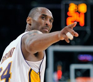 In this June 7, 2009, file photo, Los Angeles Lakers guard Kobe Bryant (24) points to a player behind him after making a basket in the closing seconds against the Orlando Magic in Game 2 of the NBA basketball finals in Los Angeles. (AP Photo/Mark J. Terrill, file)