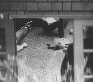 In this April 8, 1994 file photo, special investigators examine the body of Kurt Cobain, which lies on the floor of a room atop the detached garage in his home overlooking Lake Washington in Seattle. (AP Image)