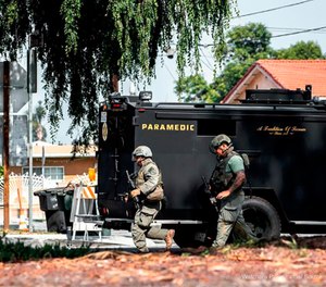 Los Angeles County sheriff's SWAT members get in to position to surround a home where an armed man is barricaded at a property in San Gabriel, Calif. (Watchara Phomicinda/The Press-Enterprise via AP)