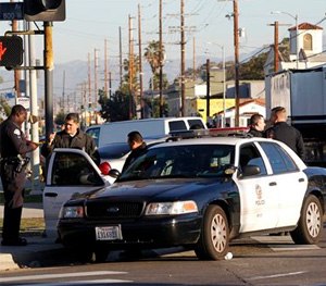 Los Angeles police officers investigate a shooting in South Central Los Angles on Monday, Dec. 29. (AP Image)