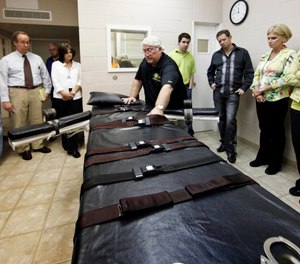 In this Sept. 18, 2009, file photo, Warden of the Louisiana State Penitentiary, Burl Cain, discusses the gurney used for lethal injections to Ruth Graham, far right and others as they visit the Louisiana State Penitentiary in Angola, La. (Photo/AP)