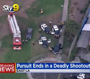 This still image taken from video provided by CBS2/KCAL9 shows the scene of gunfight at an East Los Angeles park that has wounded two Los Angeles County sheriff's deputies and left a suspect dead, Wednesday, Sept. 19, 2018. (CBS2/KCAL9 via AP)