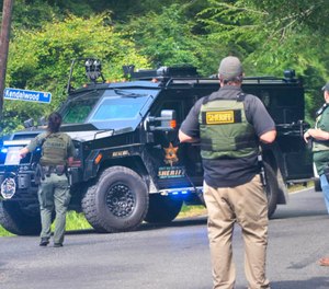 East Baton Rouge Sheriff's Office deputies stop traffic near where a search was being conducted for a suspect sought in the shooting of an EBRSO deputy. (Photo/TNS)